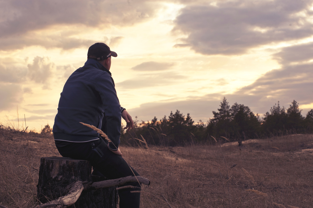 Person Sitting on Tree Log